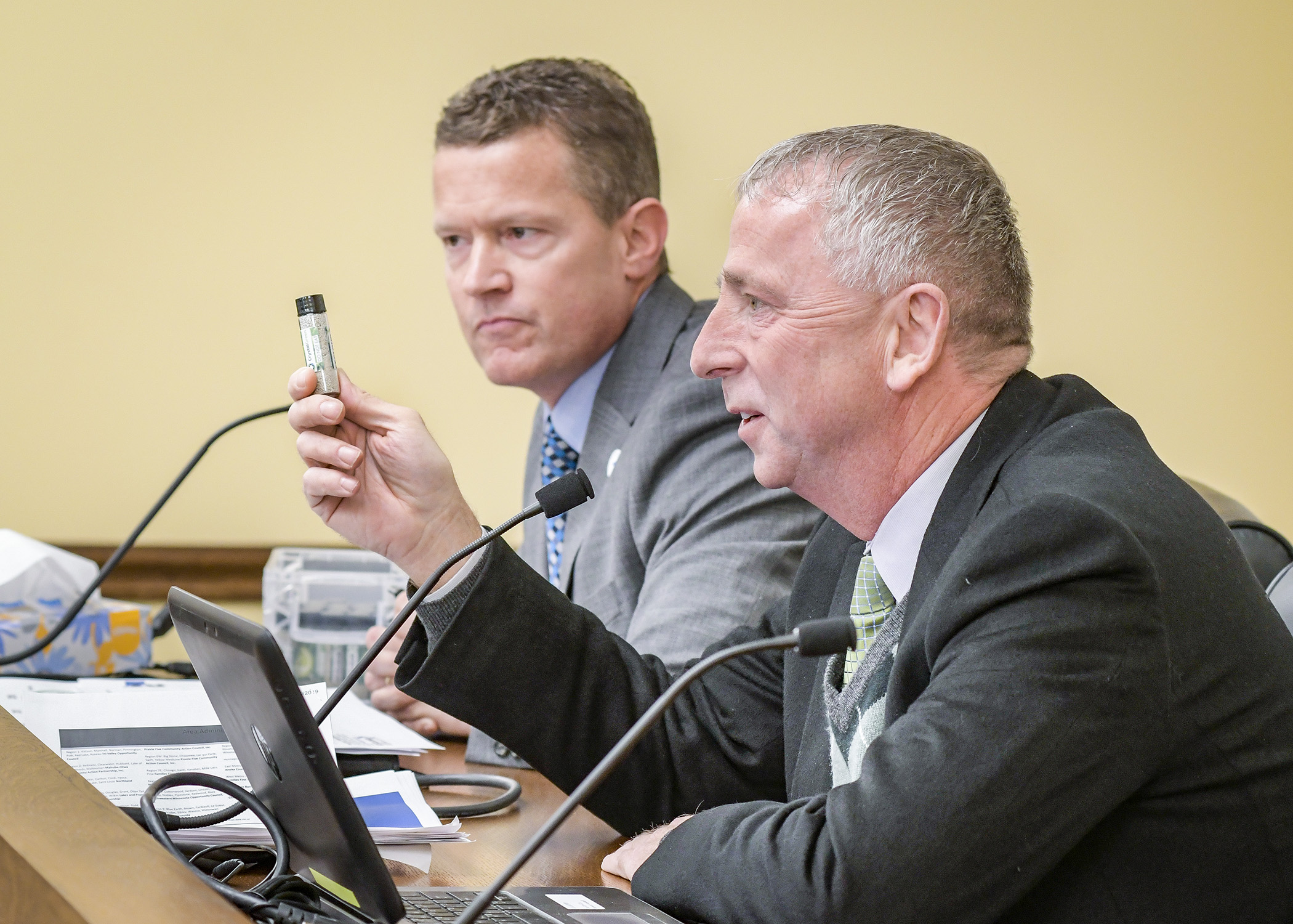 St. Cloud Mayor Dave Kleis and St. Cloud Public Services Director Patrick Shea show the House Energy and Climate Finance and Policy Division a sample of recovered phosphorus during a Jan. 31 hearing. Photo by Andrew VonBank